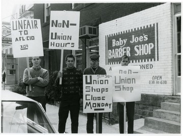 Members of the AFL-CIO 384 with signs picketing Baby Joe's Barber Shop