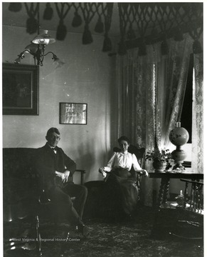 Couple sitting in a parlor room in a Morgantown home.