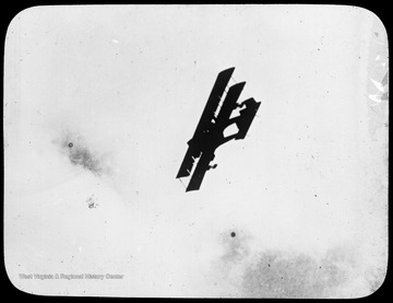 World War I Lantern Slide Show. Slide No. 33 in group of originally numbered slides.  Biplane in flight.  Frame is labelled with text saying 'Visual Bureau, University of Pittsburgh.'  (negative no. 33-1261 is inscribed on slide)<br /><br /><br />