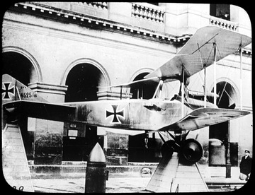 World War I Lantern Slide Show. Slide No. 41 in group of originally numbered slides.  German biplane on display in front of a building.  Frame is labelled with text saying 'Visual Bureau, University of Pittsburgh.'<br />