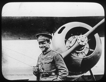World War I Lantern Slide Show. In group of originally numbered slides.  (Number label is lost.) Major Raoul Lufbery, USAS, formerly of Lafayette Escadrille in front of Nieuport 28 Pursuit plane.  Frame is labelled with text saying 'Visual Bureau, University of Pittsburgh.'