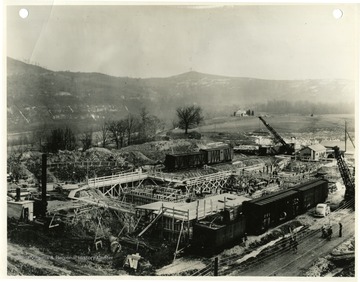 'Morgantown Ordnance Works, Morgantown, W. Va., Photograph Number 109. Picture taken from Tower No. 2 near coke plant, looking southeast showing base for oven stack on left, coal bin foundation in center, steelwork for oven battery on right. February 25, 1941 2:00 P.M.'