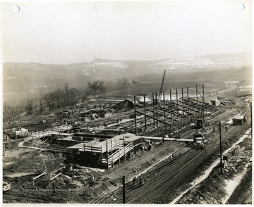 'Photograph Number 113, March 14, 1941 - 2:30 P.M. Taken from tower no. 2, looking southeast at coke oven area in foreground and foundation work on pump and exhauster building in background.'