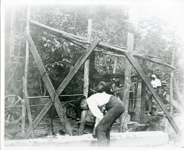 'Old spring pole drilling rig in the Volcano oil field. Taken shortly after the Civil War.'