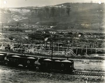 'Morgantown Ordnance Works, Morgantown, W. Va. Photograph Number 111. Taken from tower number 4. Looking West across railroad to factory building foundation work. Main office and Service buildings in left background. February 26, 1941, 2:00 P.M.'