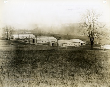 'Morgantown Ordnance Works, Morgantown, W. Va. Photograph Number 104. Temporary Construction Shops in foreground and grading in power and power recovery area in the background. Looking Northeast. February 13, 1941, 10:30 A.M.' 