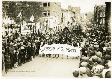 Members of University High School march down the street during the Sesquicentennial Parade in Morgantown, W. Va.