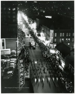 A parade goes down High Street at night in Morgantown, W. Va.