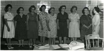 'From left to right: Mrs. Wendell Davis, Agnes Maust, Mrs. Ronald Parsons, Mrs. Lulu Roberts, Mrs. Archie Rogers, Mrs. Francis Sypolt, Mrs. John Trenton, Mrs. Mata Trembly. Mrs. D. J. Conley presented pins to volunteer workers who have 100 hours of service donated to the hospital'.
