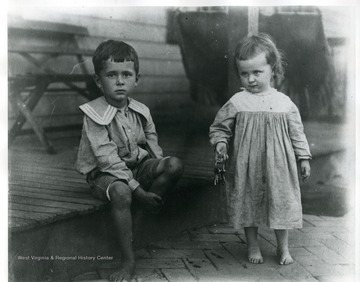 Portrait of Neal and Virginia Rumsey in front of porch.