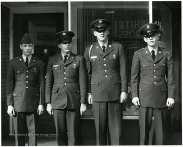 Four men in uniform in front of the U. S. Army Recruiting Station.