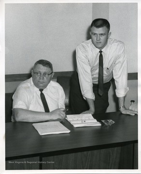 Glen White is seated on the left.