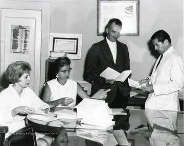 Two men are James R. McCartney, second from right and Harold Suter, far right. 