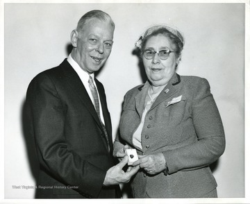 Elsie C. Baber of Morgantown, State Mother of the Year, receives a Star Heart from Mr. A. E. Haase, President, Jewelry Industry Coucil.