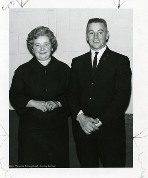 A gentleman and lady are posing for a photograph.