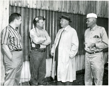 'Picture taken at the Humphrey Preparation Plant. Left to right: Bill Poundstone-Superintendent of Humphrey Mine, Elber Yocum-Member of Mine Committe (United Mine Workers of America - 1058), George Humphrey, Ray Hayhurst-Lampman at Humphrey Mine Portal and first President of Humphrey local Union.'