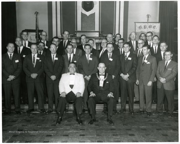 Man in the front row wearing the white jacket is Rex Wolfe.  Fourth from right in first row is Vince Mancinelli.  Second from right in the second row is Guy Flinn.  