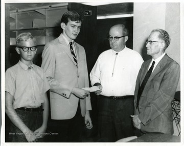Danny Blosser (far left) and Dan Fetton (second from left) are pictured with Mr. Fetton and Dr. Earl L. Core (far right) in this photograph.