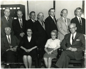 Harlan Selby (seated, far right), Mrs. Rogers (seated, second from right), Robert H. Bowlby (standing, center) and Arthur P. Dye (seated, far left).