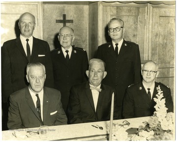 On the far left standing is Charles Wiston.  Sitting in the middle is William H. Ryder.