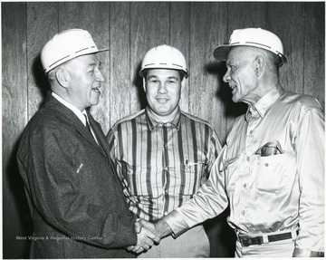 From left to right: 'Geo Humphrey, Bill Poundstone-Superintendent of Humphrey Mine, Ray Hayhurst- President of Humphrey mine local Union (United Mine Workers of A-1058) at time mine was first opened. Presently lampman at mine portal where picture was taken.' 