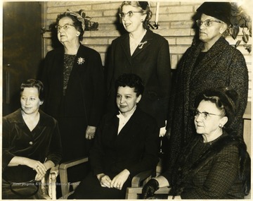 Sitting on the right is Mrs. A. H. VanLandingham.  Standing from left to right: Unknown, Mrs. Hal Phillips, and Grace Waters.