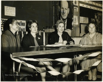 'Rose Salucci' on the far left sitting with other women at a table. 