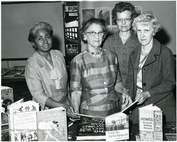 African-American woman at left is Mrs. Gladys Peyton.  She was a third grade teacher at Second Ward Grade School.  Mrs. Ralph Ryan third from left. 