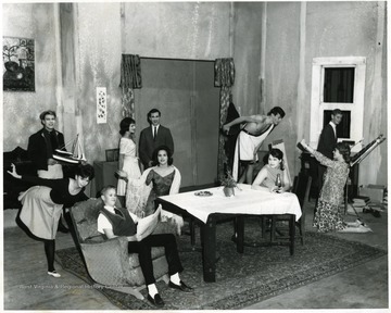 Front Row, left to right: Jan Helmick, Tom Lloyd, unknown at table, Marilee Rockenstien (with bottle), Kim Coy.  Back row, left to right:  Bob Snyder, Bettijane Christopher, Bob Verbosky, unknown in toga, and Dick Mullendore