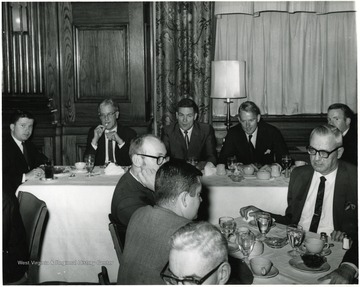 Seated at the back table, from left to right:  John Patrick Ball, Judge Don J. Eddy, Dean Paul L. Selby, Edgar F. Haskell III and Robert W. Dinsmore.  At the front table on the far right is Oakley J. Hopkins, and facing directly in front of him is Charles Haden II.