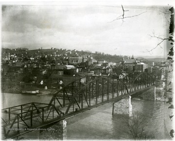 People can be seen crossing the bridge which spans the Monongahela River leading into Morgantown, W. Va. 