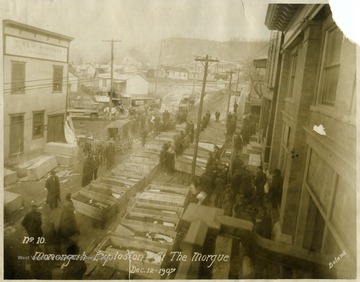 Caskets line the street which served as a makeshift morgue for the miners killed in the explosion at the Fairmont Coal Company Monongah Mines.  Note: image is taken from the original print donated to the West Virginia Collection.