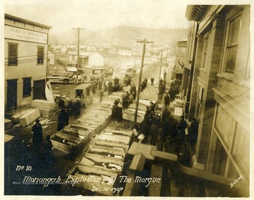 Caskets line the street which served as a makeshift morgue for the miners killed in the explosion at the Fairmont Coal Company Monongah Mines. Note: image is taken from the original print donated to the West Virginia Collection.