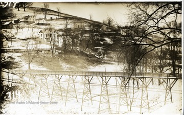 'Sunnyside foot bridge showing houses at the intersection of Stewart Street and Jones Avenue, taken from Woodburn Hall.'