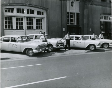 City police department patrol cars in front of City Building on Spruce Street. From left to right: Chief John Lewis, Lieut. Sam Davis, Patr. Charles Cira, Patr. George Katchur.