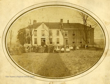 Students pose in front of Woodburn Seminary in Morgantown, West Virginia. 'Woodburn Seminary was used by West Virginia University until February 1873, when it burned.'
