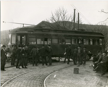 Men stand near a Sabraton Railway car.