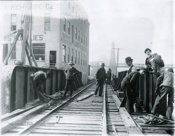 Men working on the railroad trestle at the foot of Walnut Street.