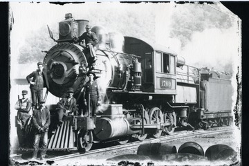 Six railroad workers pose in front of Baltimore and Ohio Engine 1769.  'Class E-19a.  21x30". Numbered 1766 to 1899, 1939, 1940, and 1959 to 1965. See Sagle, p. 109.  Baldwin.'
