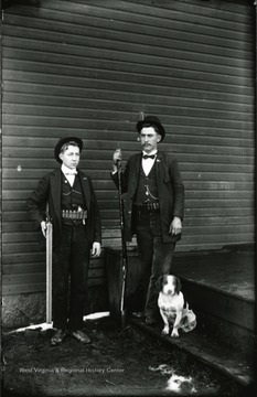 A portrait of Spindler and King with a dog.