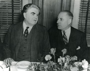 John L. Lewis and M. M. Neely sitting at a table.
