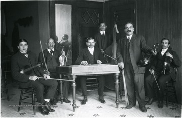 Six members of a musical group with their musical instruments.