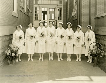 Group portrait of nine nurses.