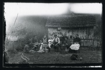 The Cole Family is making apple butter at John G. Cole's House in Morgantown, West Virginia. '1st row: Cole Family: Spencer, John G., Don (Everett), Spencer's wife Ethel, Avis, Foster, Cora and Lide.'