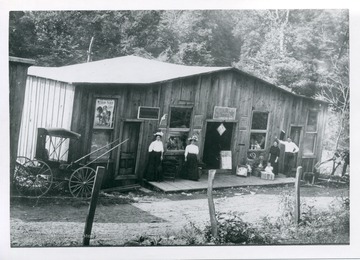 View of two women standing in front of a general store in Mapleton, 'left to right: Mrs. Lena D. Mollohan McClain and Mrs Ella P. Mollohan Faust.'