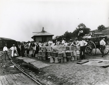 View of fruit harvest group waiting for the train at the Romney B and O passenger freight station.