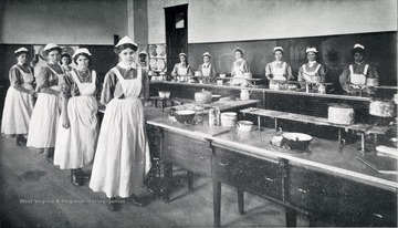 Scene of girls in a domestic science class at the West Virginia Industrial Home for Girls.