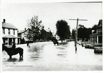 View of men on horseback in flooded streets of Moorefield, W. Va