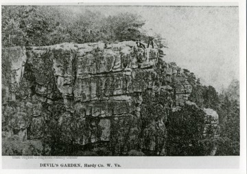 Two unidentified men on the steep cliffs of Devil's Garden in Hardy County.