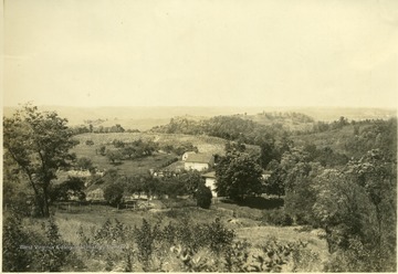 'George Sennett's farm. A typical 'ridge' farm, between Murrayville and Lone Cedar. On the ridges, the farm land is rougher and the farms are further apart.' From photo album labeled 'Stewart A. Cody, County Agent, Jackson County, 1912.'